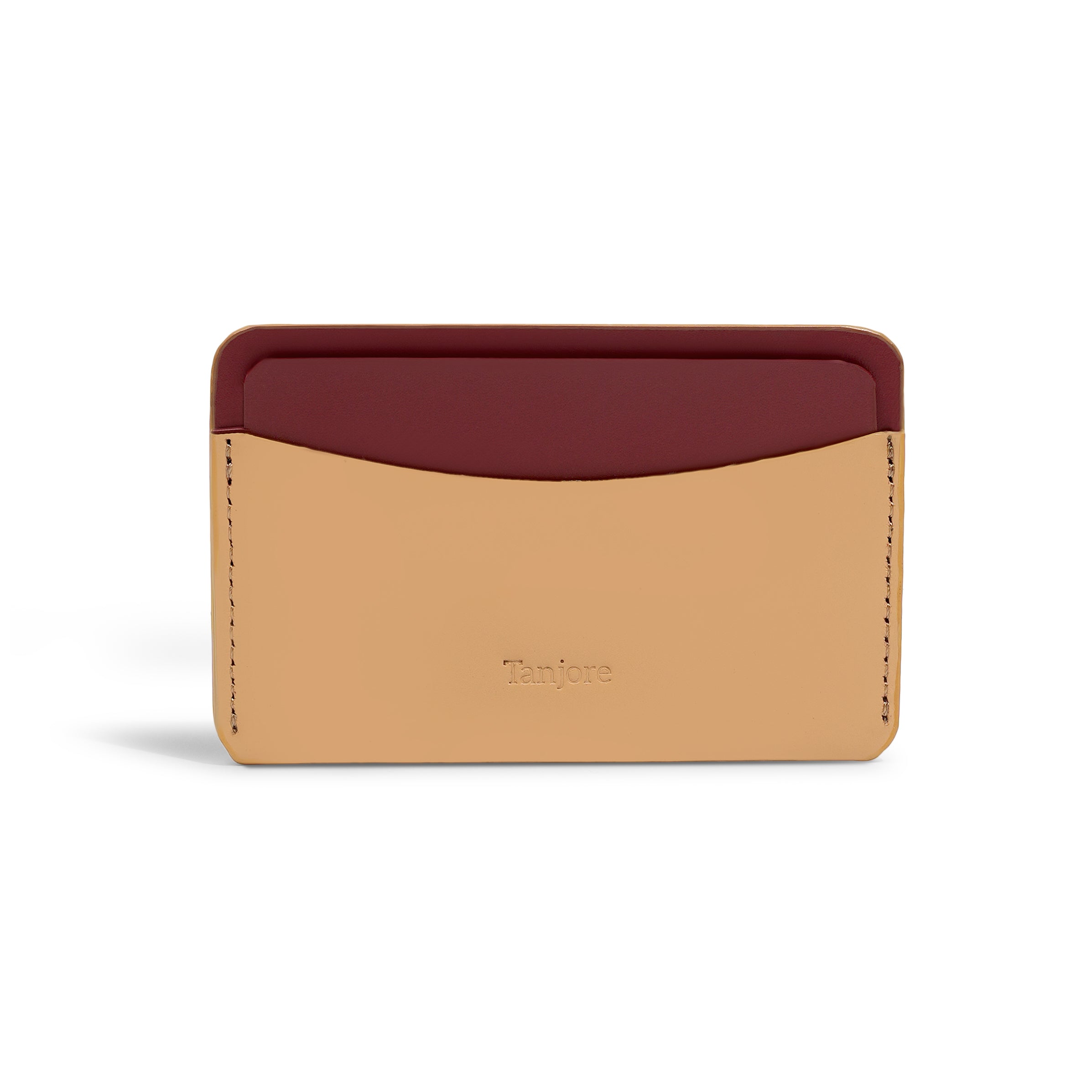 Front view of the minimalist Tanjore wallet in a two-tone Clay and Plum finish. Crafted from premium Full Grain Nappa Leather with the brand logo embossed.