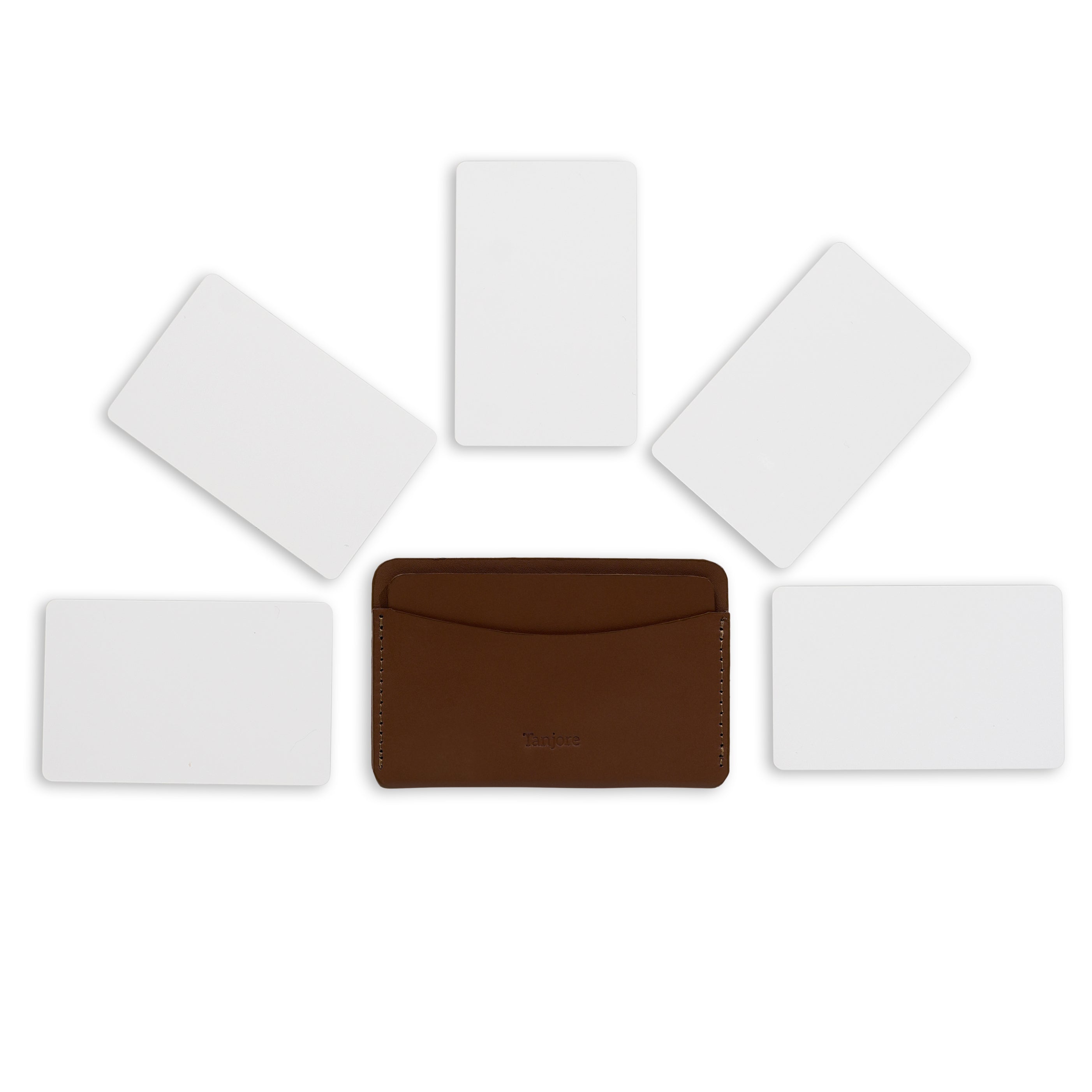 Overhead view of the Brown Tanjore cardholder surrounded by five cards to demonstrate daily carry storage capacity. Made from Full Grain Nappa Leather.