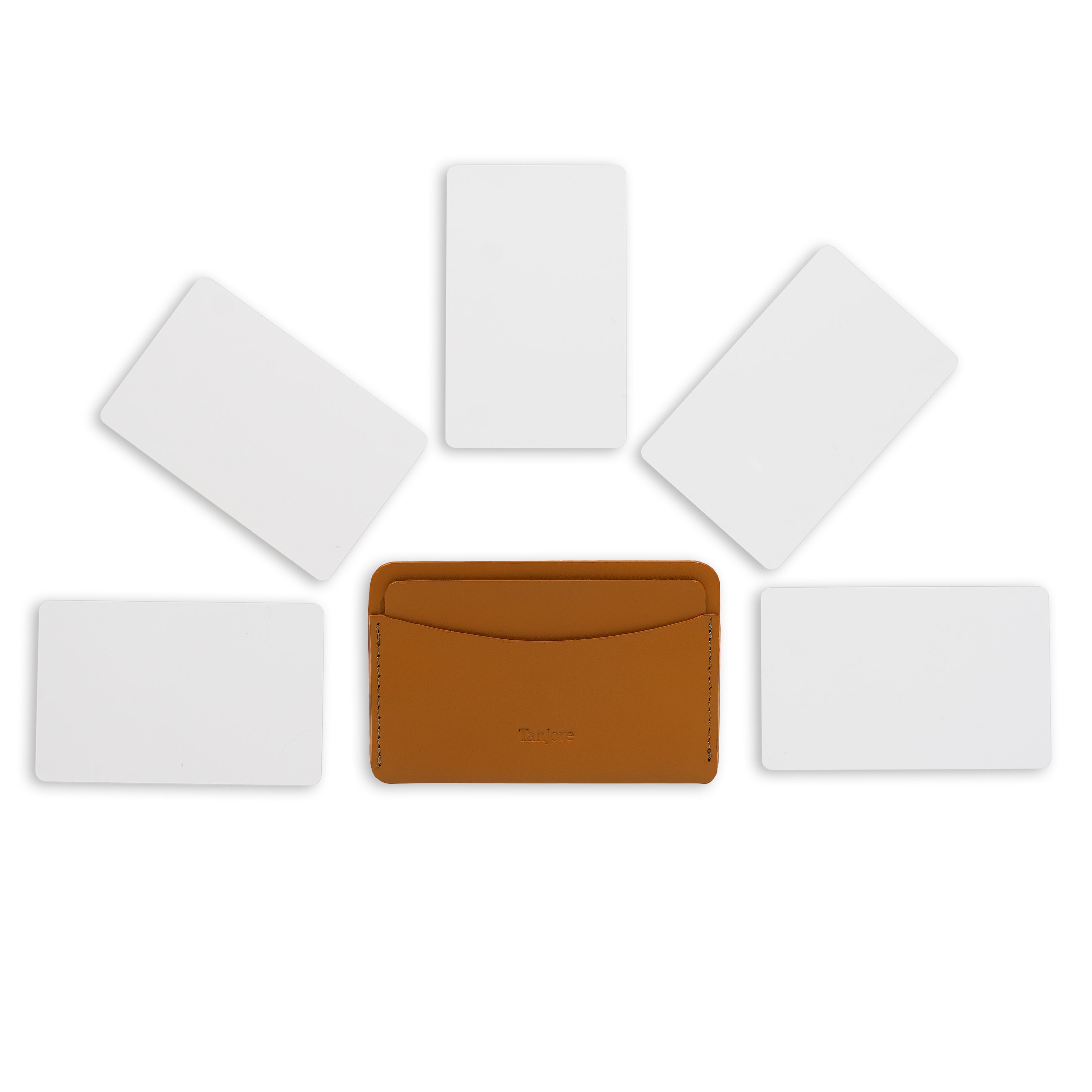 Overhead view of the Tan Tanjore cardholder surrounded by five cards to demonstrate daily carry storage capacity. Made from durable Full Grain Nappa Leather.