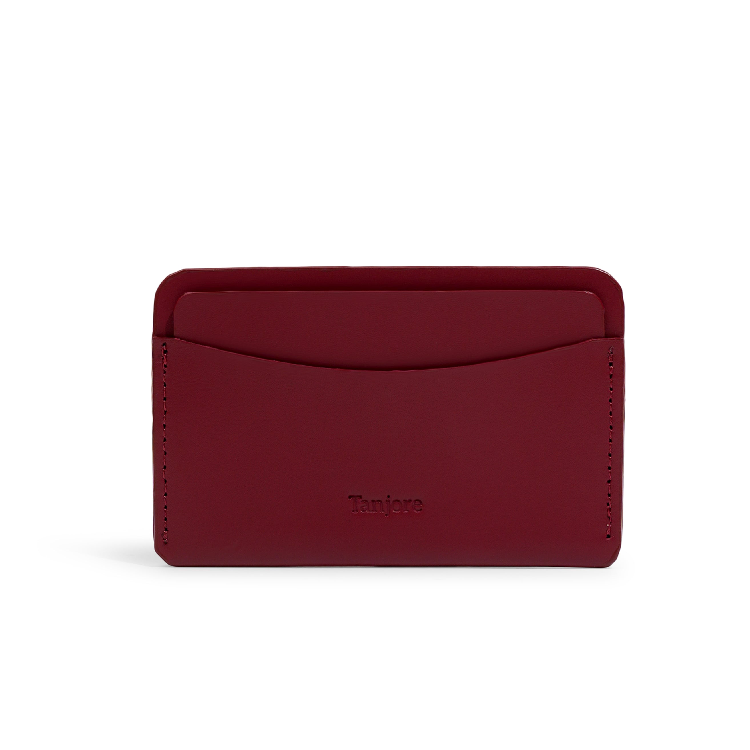 Front view of the minimalist Tanjore wallet in deep Plum. Crafted from premium Full Grain Nappa Leather with the brand logo embossed and a 3 year warranty.