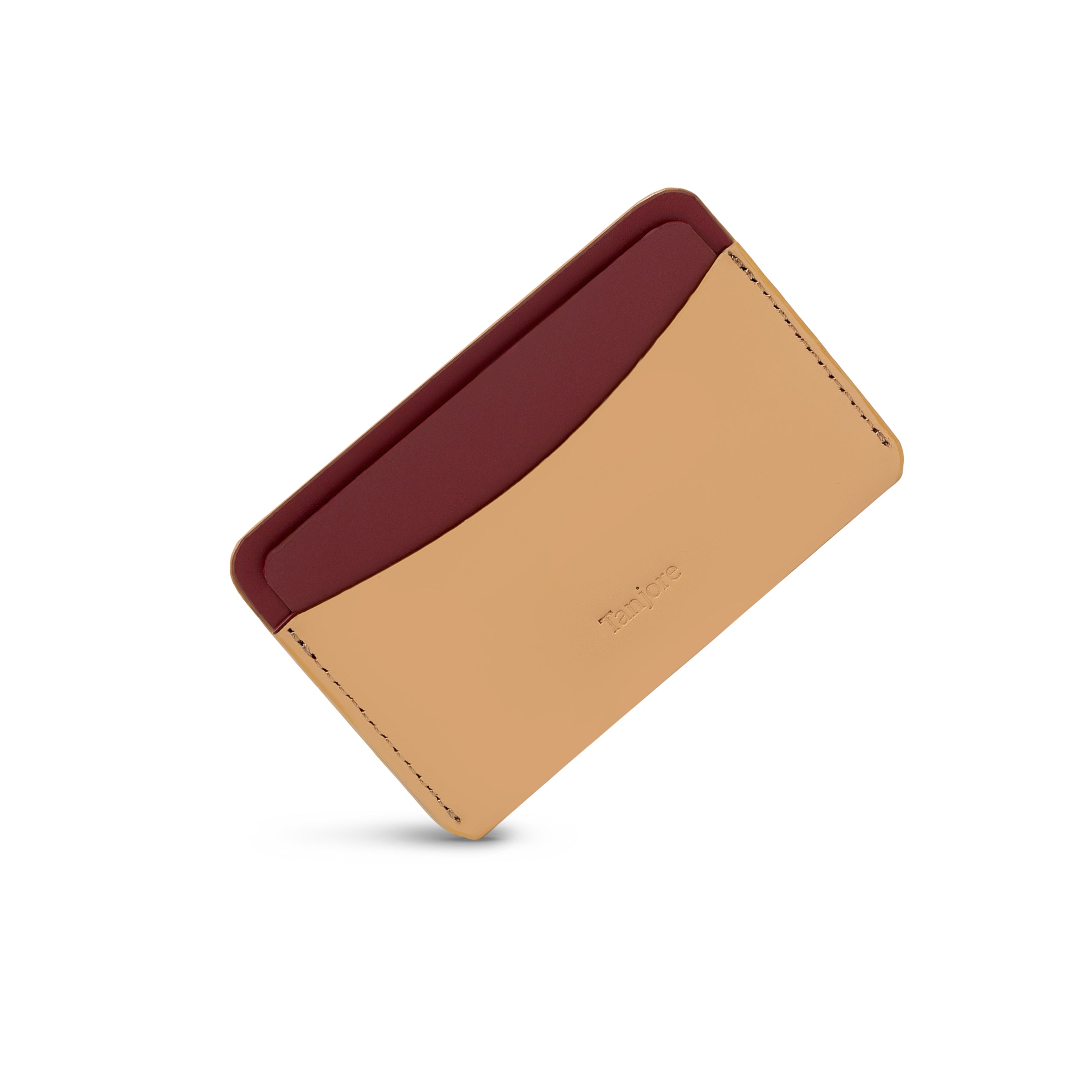 An angled perspective of the ultra-slim Tanjore cardholder in Clay and Plum. The durable Full Grain Nappa Leather design is backed by a 3 year warranty.
