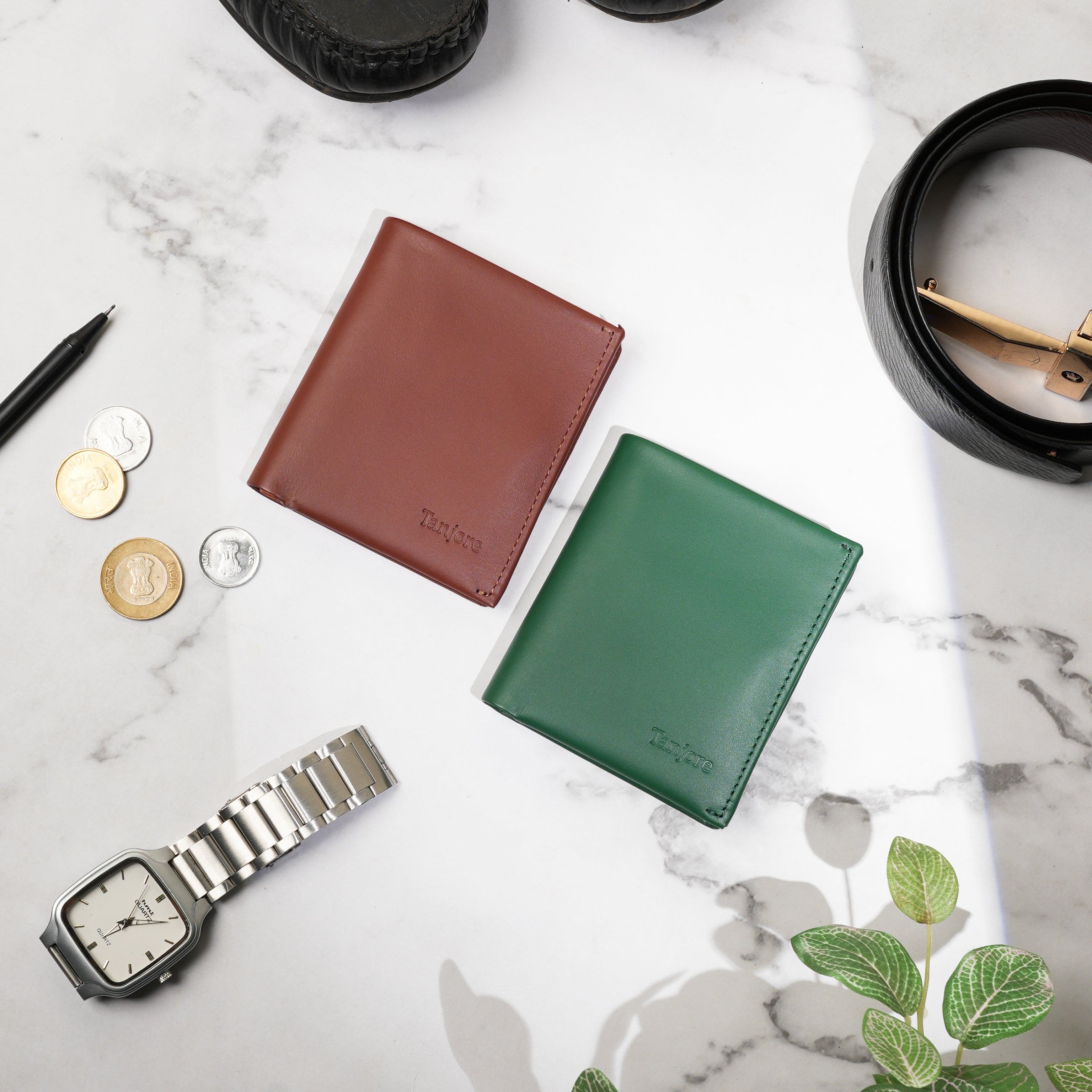 Bright minimalist workspace shot featuring Tanjore Reserve Sleeves in Brown and Green. Highlighting the sleek texture of the Full Grain Nappa Leather.